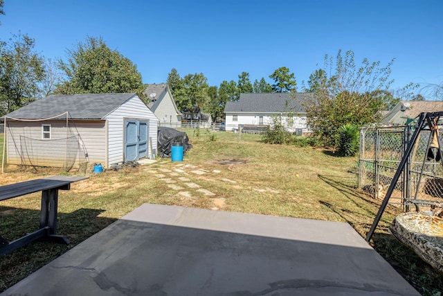 view of yard featuring a storage shed and a patio area