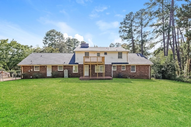 back of property featuring a balcony and a lawn