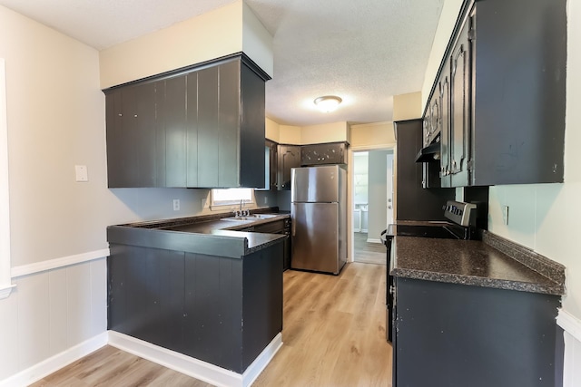 kitchen featuring sink, stainless steel fridge, black range with electric stovetop, and light hardwood / wood-style floors