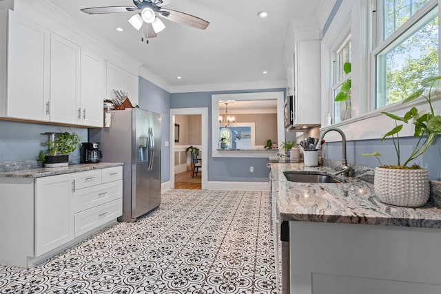 kitchen with light stone countertops, appliances with stainless steel finishes, and white cabinets