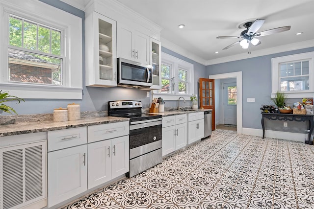 kitchen featuring crown molding, appliances with stainless steel finishes, and plenty of natural light