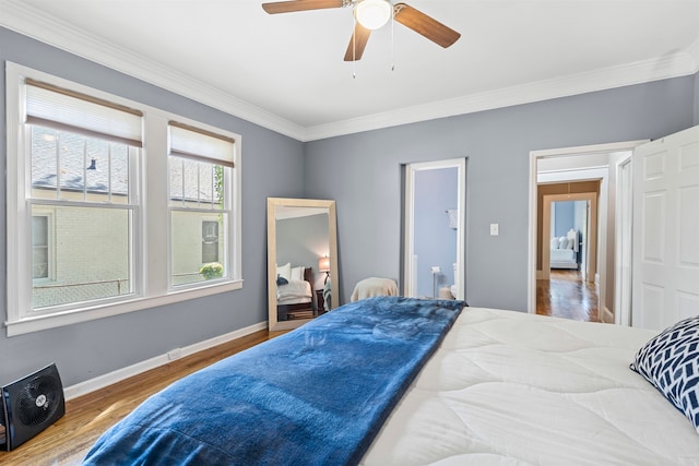 bedroom with ceiling fan, wood-type flooring, and ornamental molding