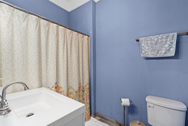 bathroom with toilet, crown molding, vanity, and wood-type flooring