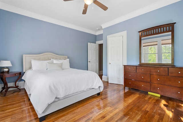 bedroom with ornamental molding, hardwood / wood-style floors, and ceiling fan