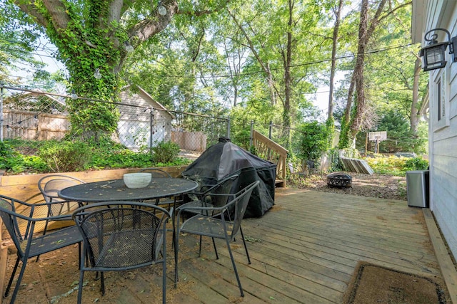 wooden deck with a grill