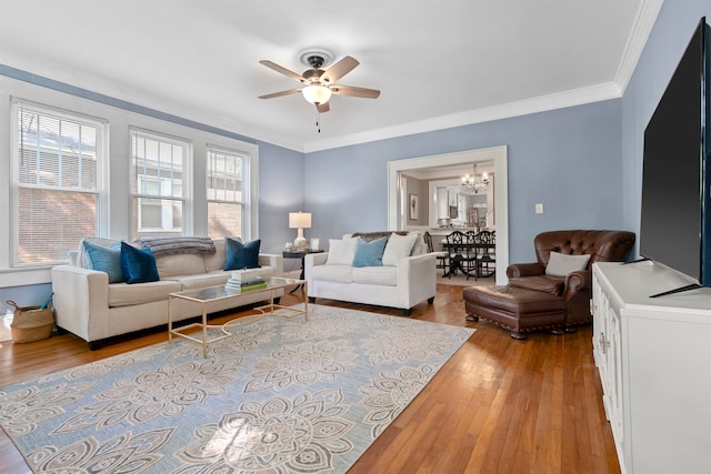 living room with light hardwood / wood-style flooring, ceiling fan with notable chandelier, and crown molding