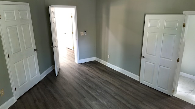 unfurnished bedroom with dark hardwood / wood-style floors