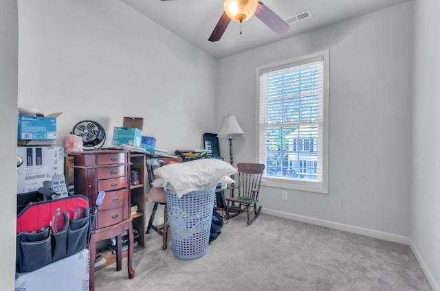 carpeted office space featuring ceiling fan