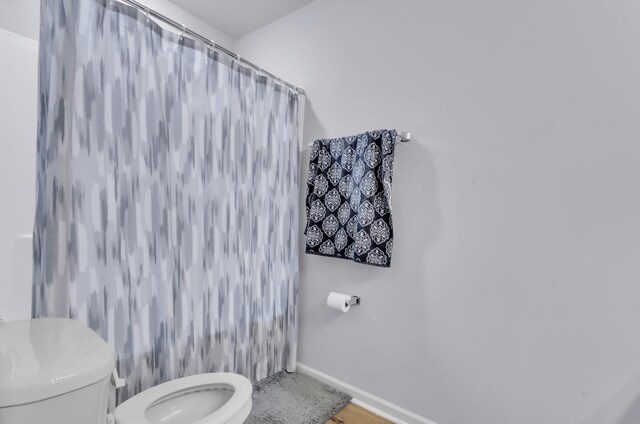 bathroom with toilet and walk in shower