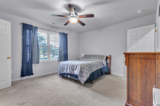 bedroom with ceiling fan and light carpet