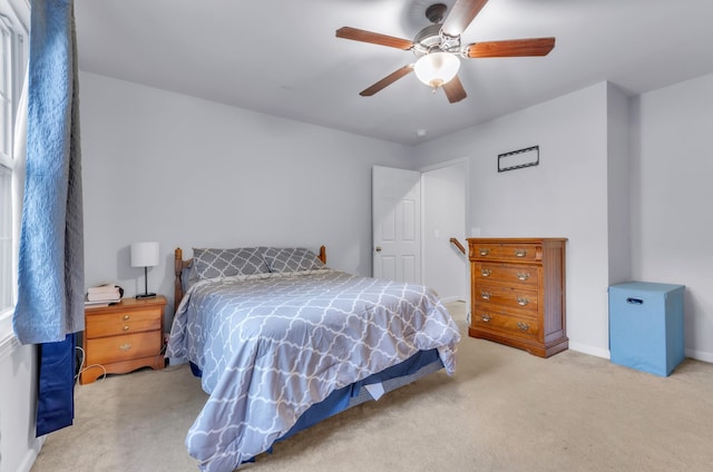 bedroom featuring light carpet and ceiling fan