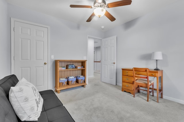 sitting room featuring light colored carpet and ceiling fan