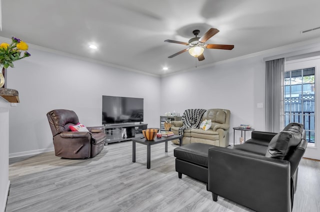 living room with ornamental molding, light hardwood / wood-style flooring, and ceiling fan