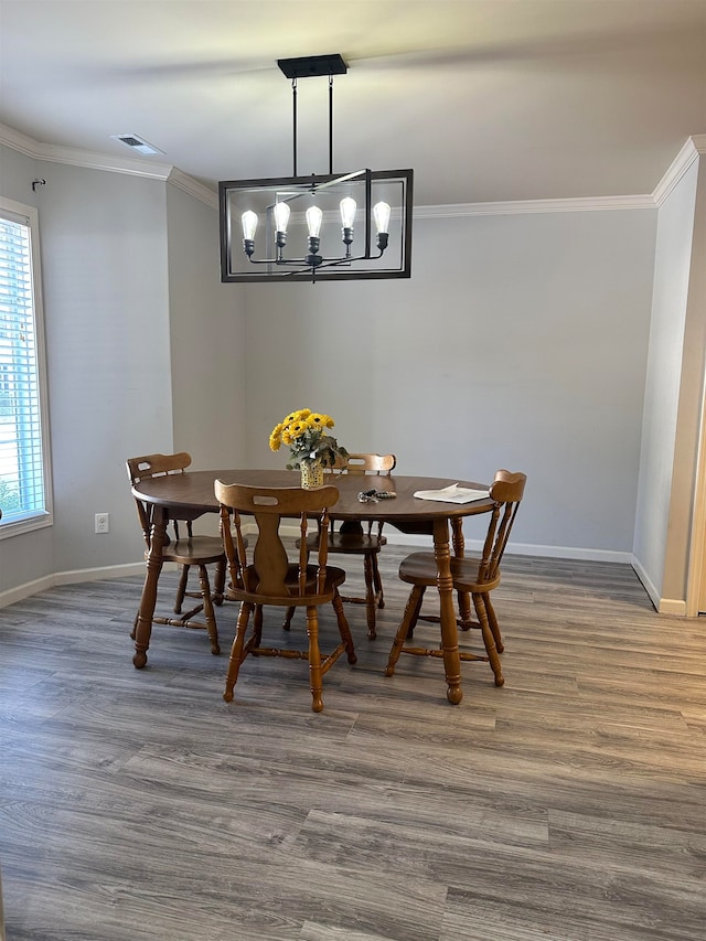 dining area featuring ornamental molding and wood-type flooring