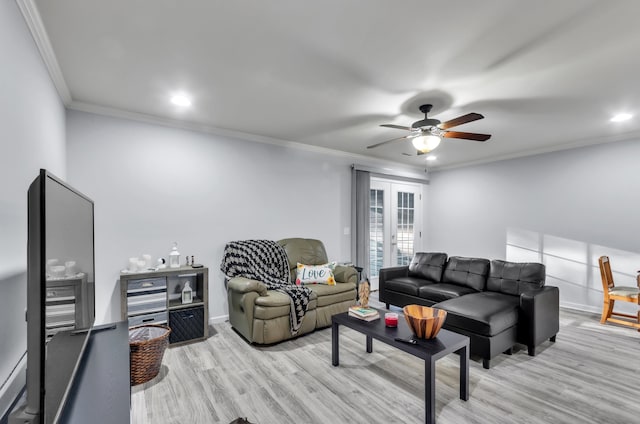 living room with ceiling fan, ornamental molding, and light wood-type flooring