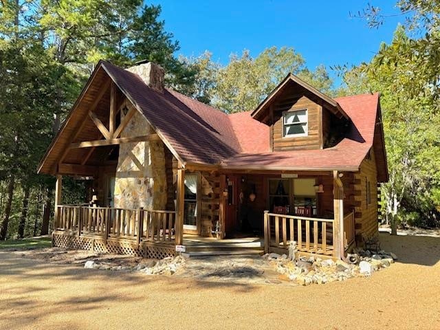 log-style house with a porch