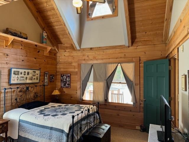 bedroom featuring beam ceiling, multiple windows, and wooden walls