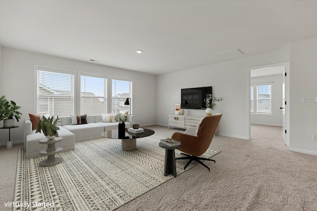 living room with light carpet and a wealth of natural light