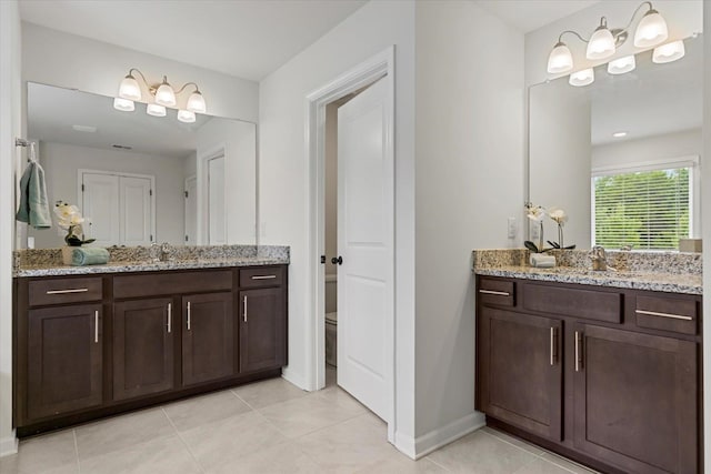 bathroom with vanity, toilet, and tile patterned floors