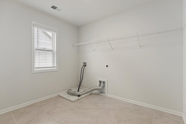 washroom with electric dryer hookup, light tile patterned floors, and hookup for a washing machine