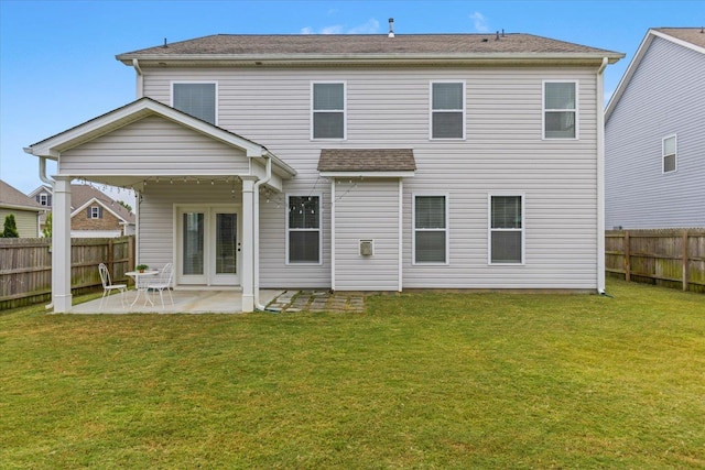 back of property with a patio and a lawn