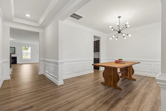 interior space featuring dark wood-type flooring, crown molding, and an inviting chandelier