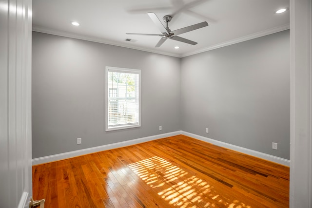 unfurnished room featuring hardwood / wood-style floors, crown molding, and ceiling fan