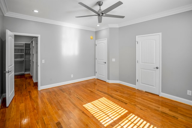 unfurnished bedroom featuring ornamental molding, hardwood / wood-style flooring, and ceiling fan