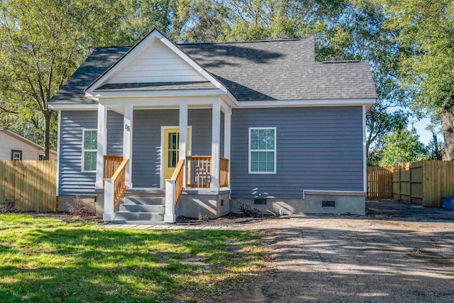 bungalow-style house with covered porch and a front lawn