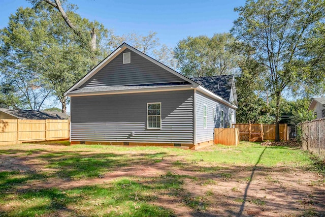 rear view of house featuring a lawn