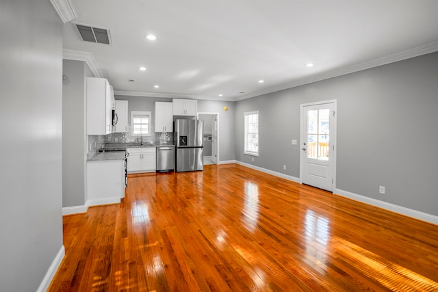 kitchen featuring white cabinetry, light hardwood / wood-style floors, and appliances with stainless steel finishes