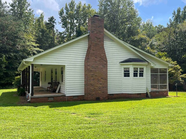 view of side of home featuring a yard