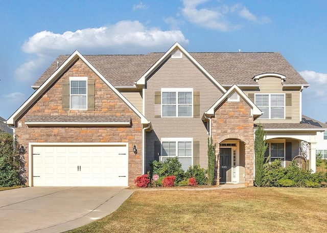 view of front of home featuring a front lawn and a garage