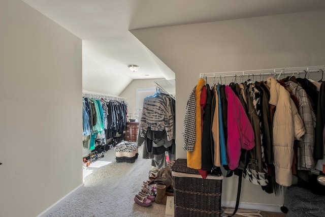 spacious closet with carpet floors and vaulted ceiling