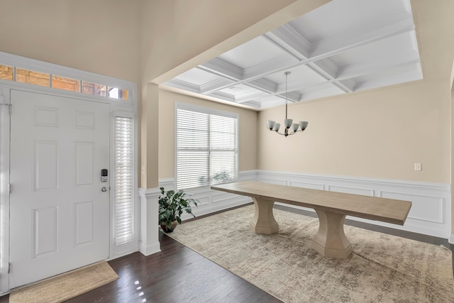 entrance foyer featuring beamed ceiling, coffered ceiling, a notable chandelier, and dark hardwood / wood-style flooring