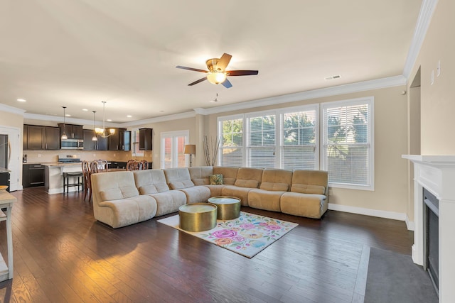 living room with crown molding, ceiling fan, and dark hardwood / wood-style flooring