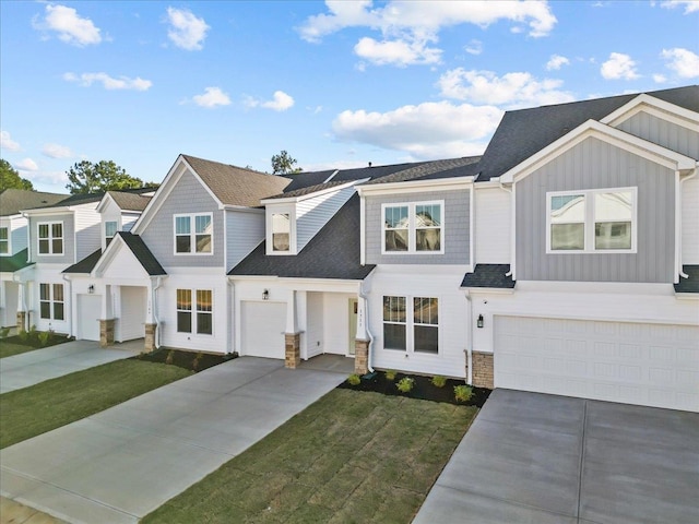 view of property with a front lawn and a garage