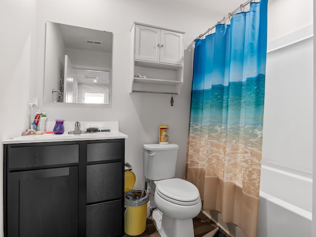 full bathroom with toilet, shower / bath combo with shower curtain, and vanity