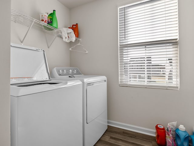 washroom with dark wood-type flooring and separate washer and dryer