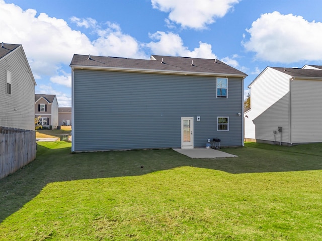 back of property featuring a yard and a patio area