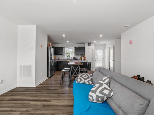 living room with dark hardwood / wood-style flooring