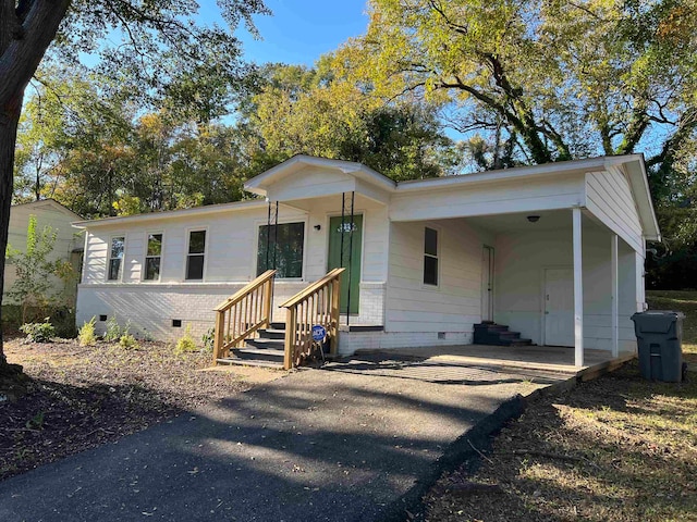 view of front of home featuring a carport