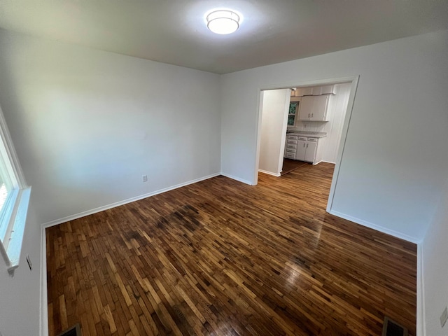 spare room with dark hardwood / wood-style floors