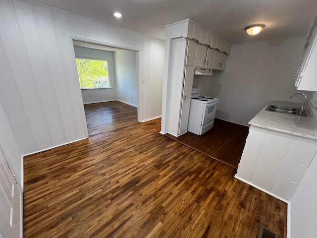 kitchen with white cabinetry, dark wood-type flooring, white electric range, and sink