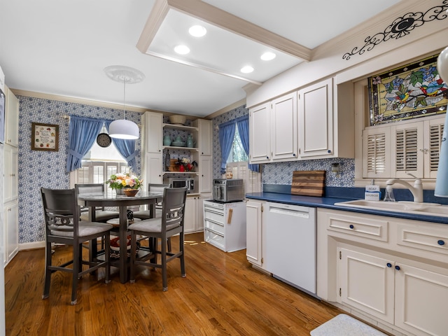 kitchen with dishwasher, white cabinets, plenty of natural light, and pendant lighting