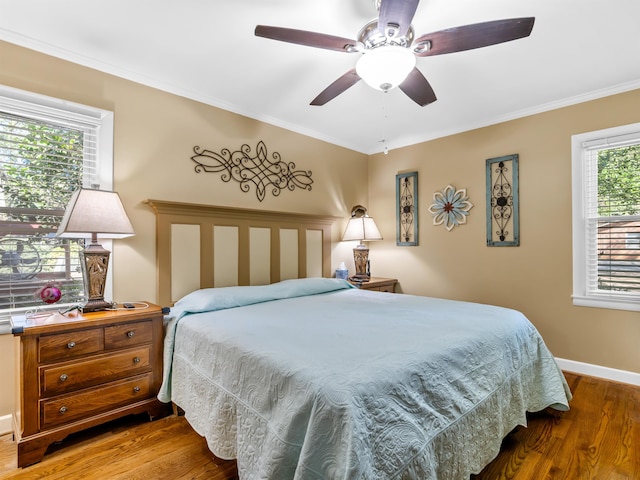 bedroom featuring ornamental molding, hardwood / wood-style flooring, and ceiling fan