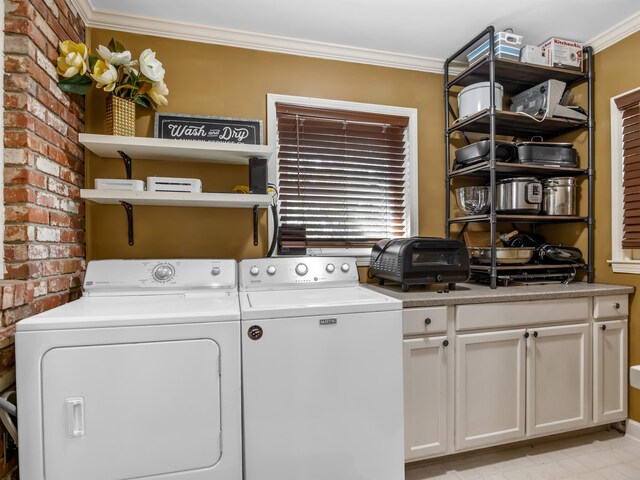 laundry area with cabinets, crown molding, brick wall, and separate washer and dryer