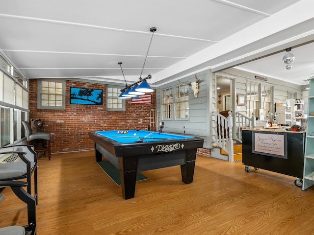 rec room featuring brick wall, pool table, and hardwood / wood-style floors