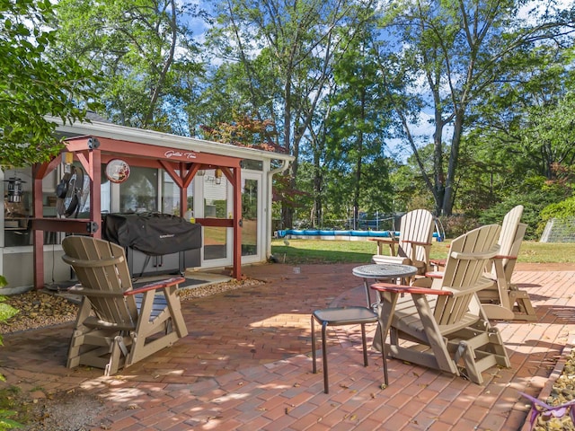 view of patio / terrace featuring a gazebo, grilling area, and a pool