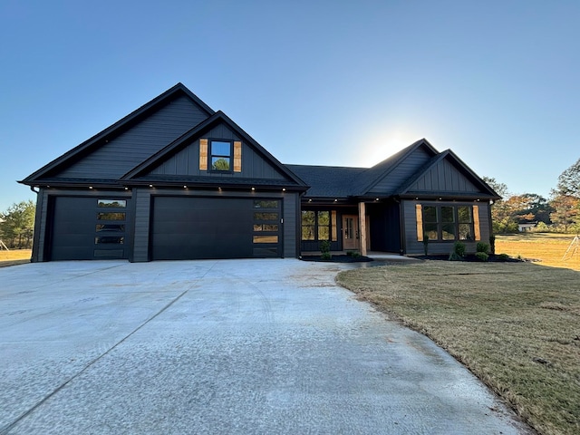 view of front of property with a front yard and a garage